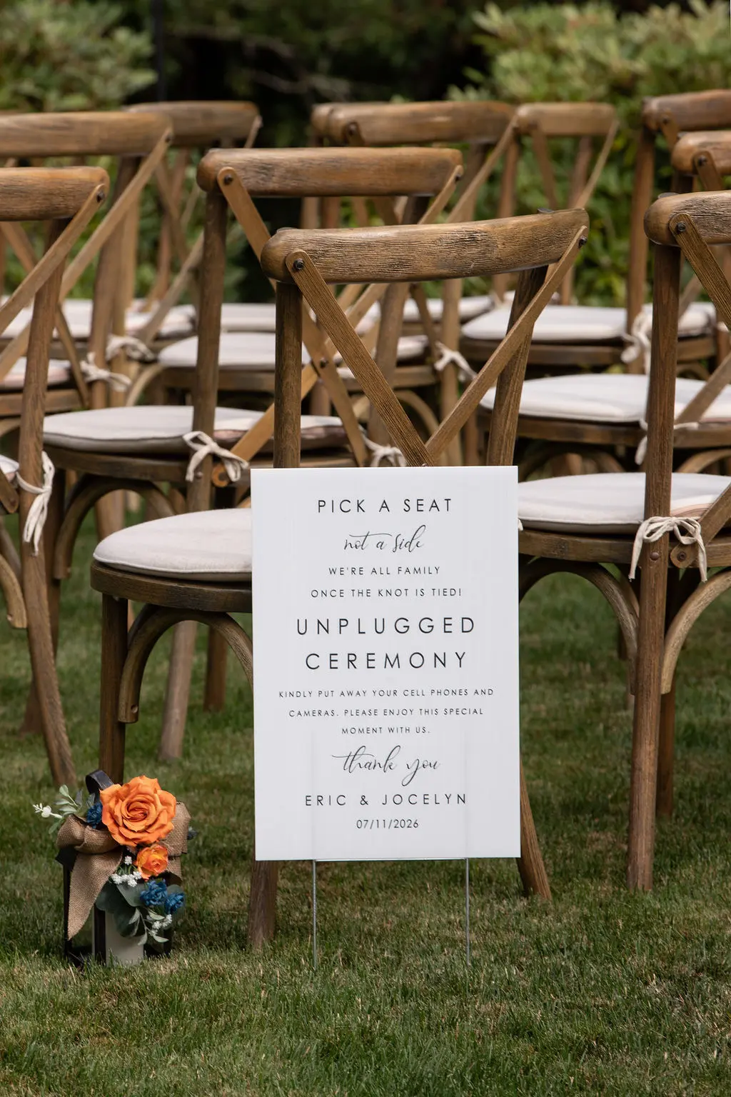 Unplugged ceremony sign and wooden chairs