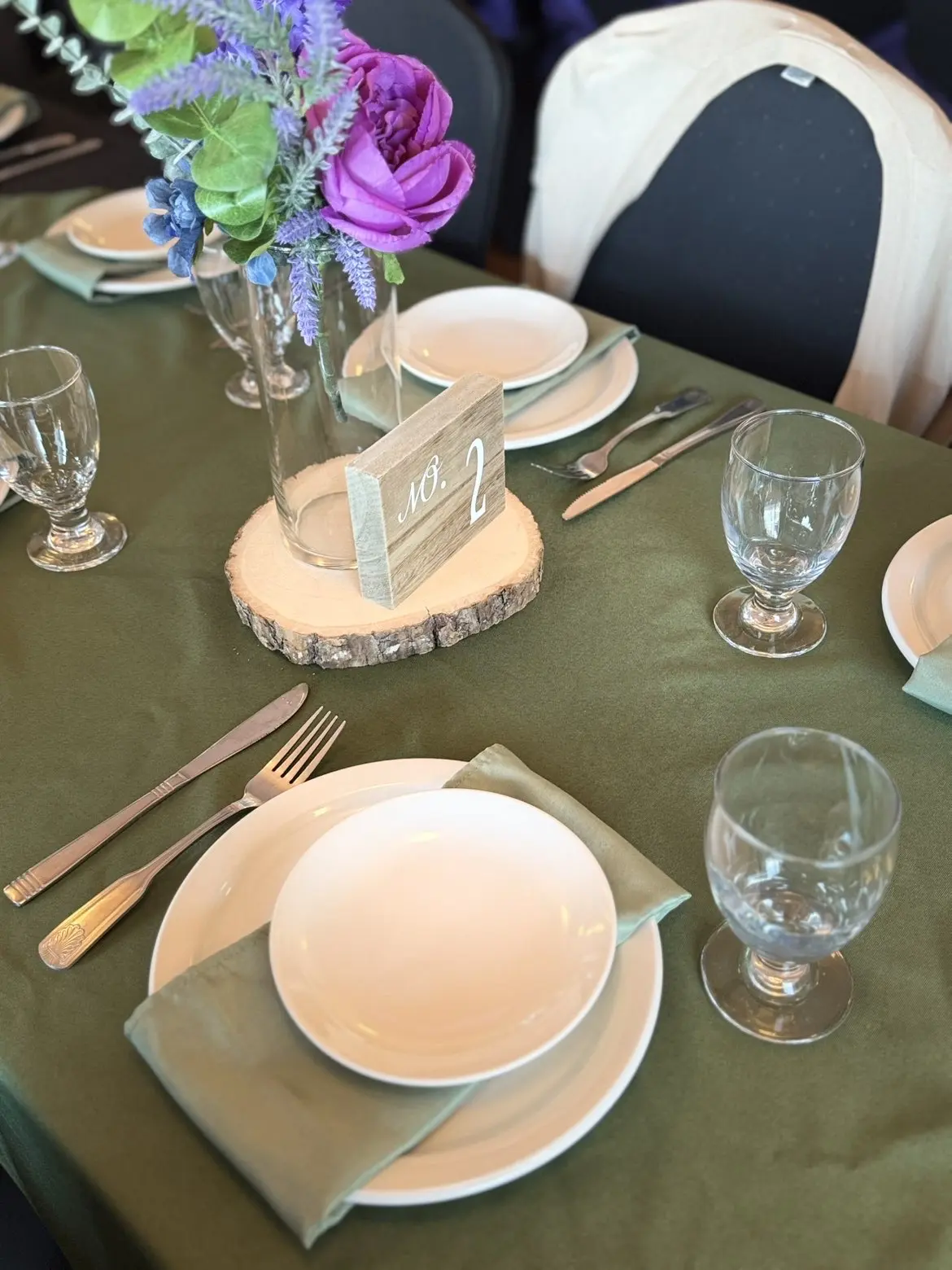 Green reception table with floral centerpiece