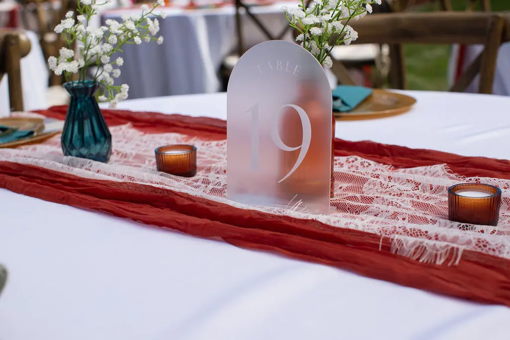 Table number nineteen among lace and colorful glass
